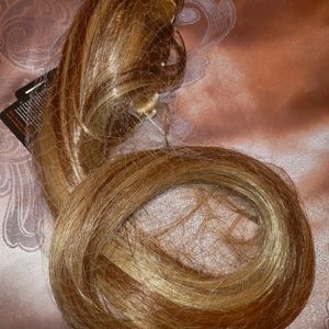 Long clip on pony tail in a honey blonde with highlights 18" inches long.